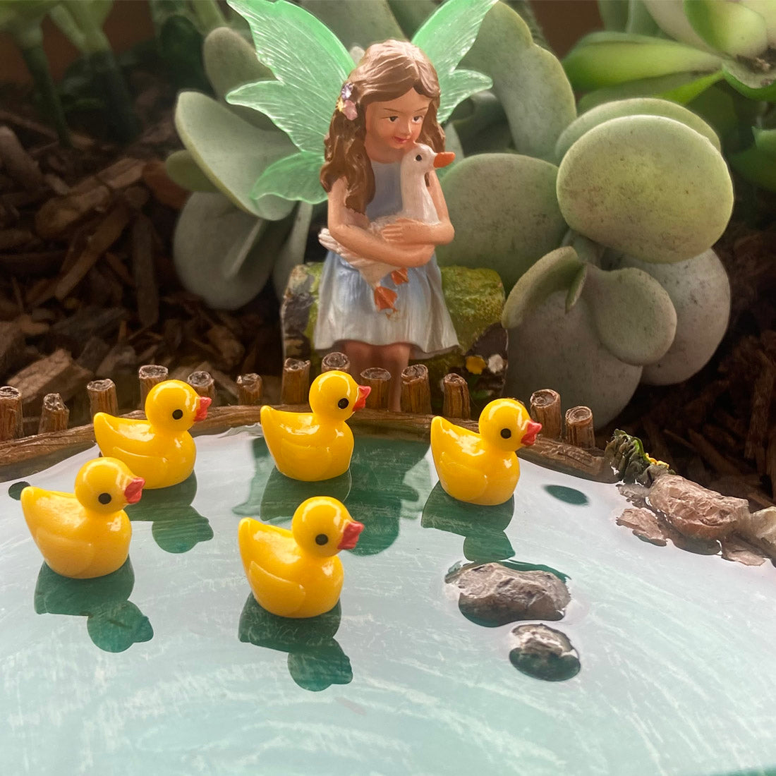 Fairy Sitting on Log Holding Duck Figurine