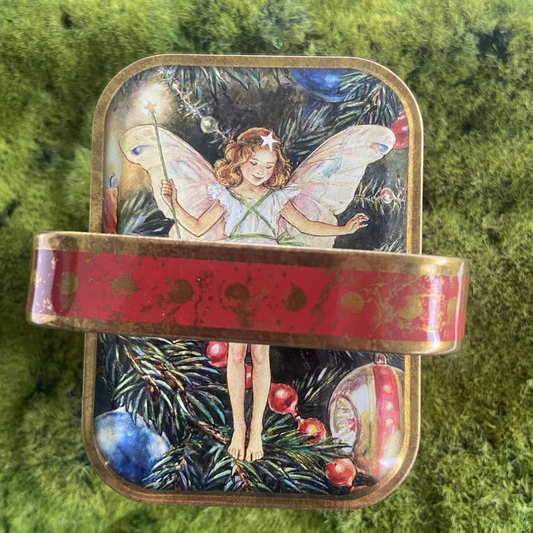Decorative tin with fairy design on a green background
