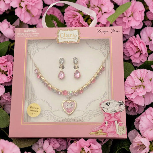 A pink jewelry gift set in a branded claris box, featuring a beaded necklace with a heart pendant and matching teardrop earrings.