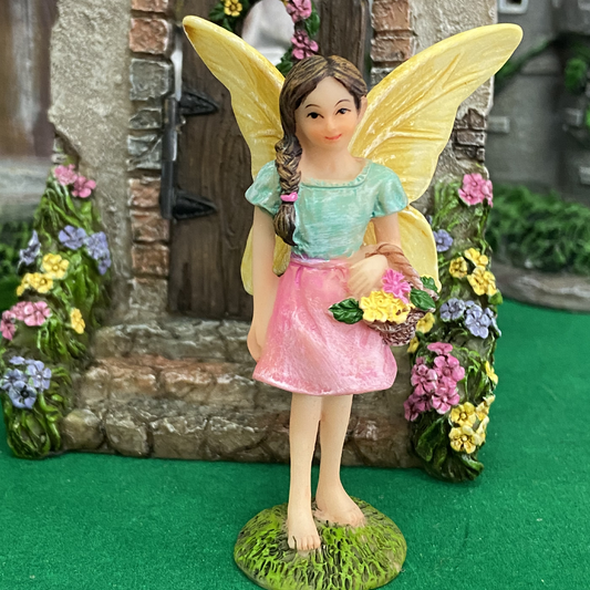 fairy standing 8cm tall holding a basket of flowers