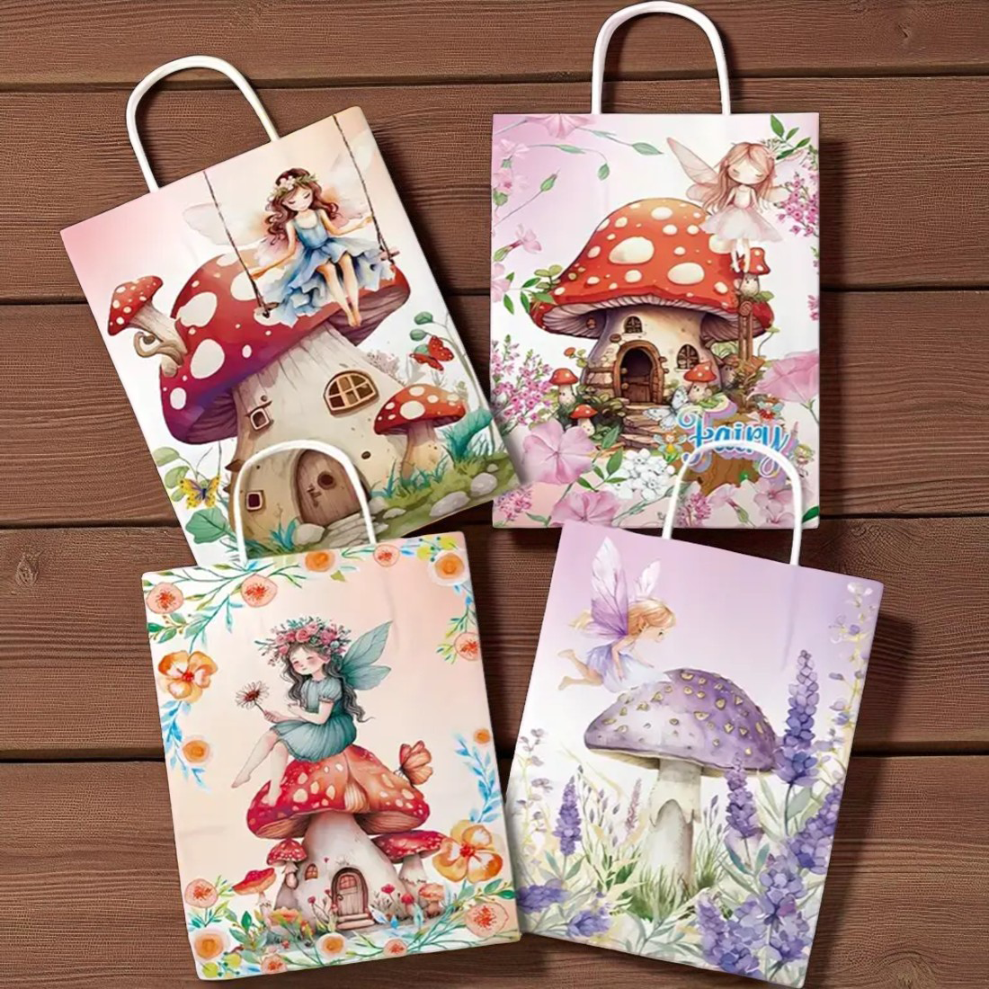 Four colorful gift bags with fairy and mushroom designs on a wooden surface.
