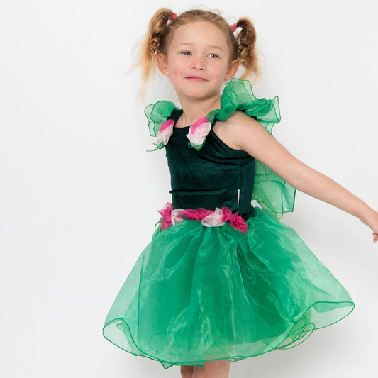 A young girl wearing a green fairy costume with a velvet bodice, organza skirt, and rose flower detail, complete with attached handmade wings.