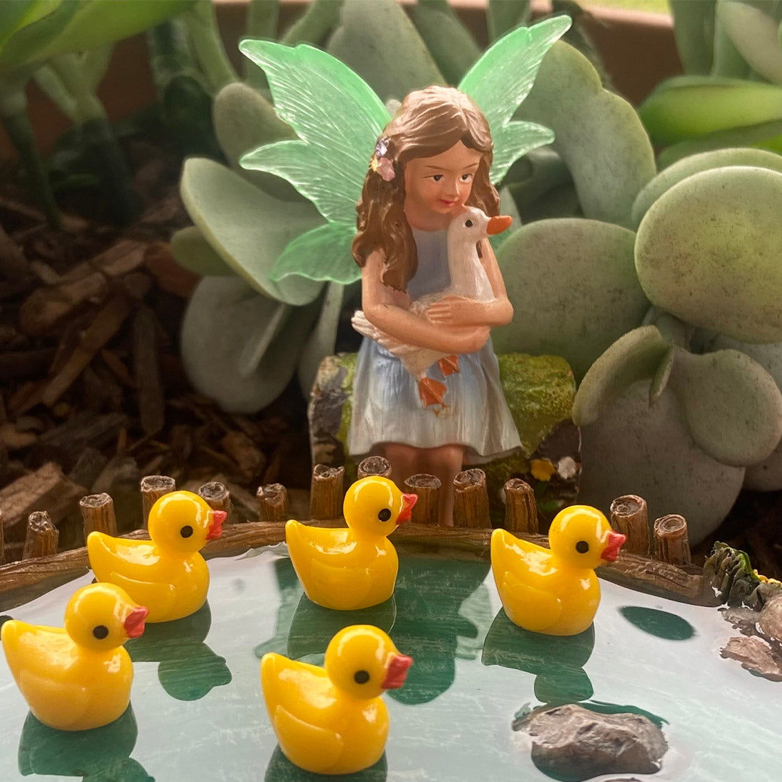 Fairy Sitting on Log Holding Duck Figurine
