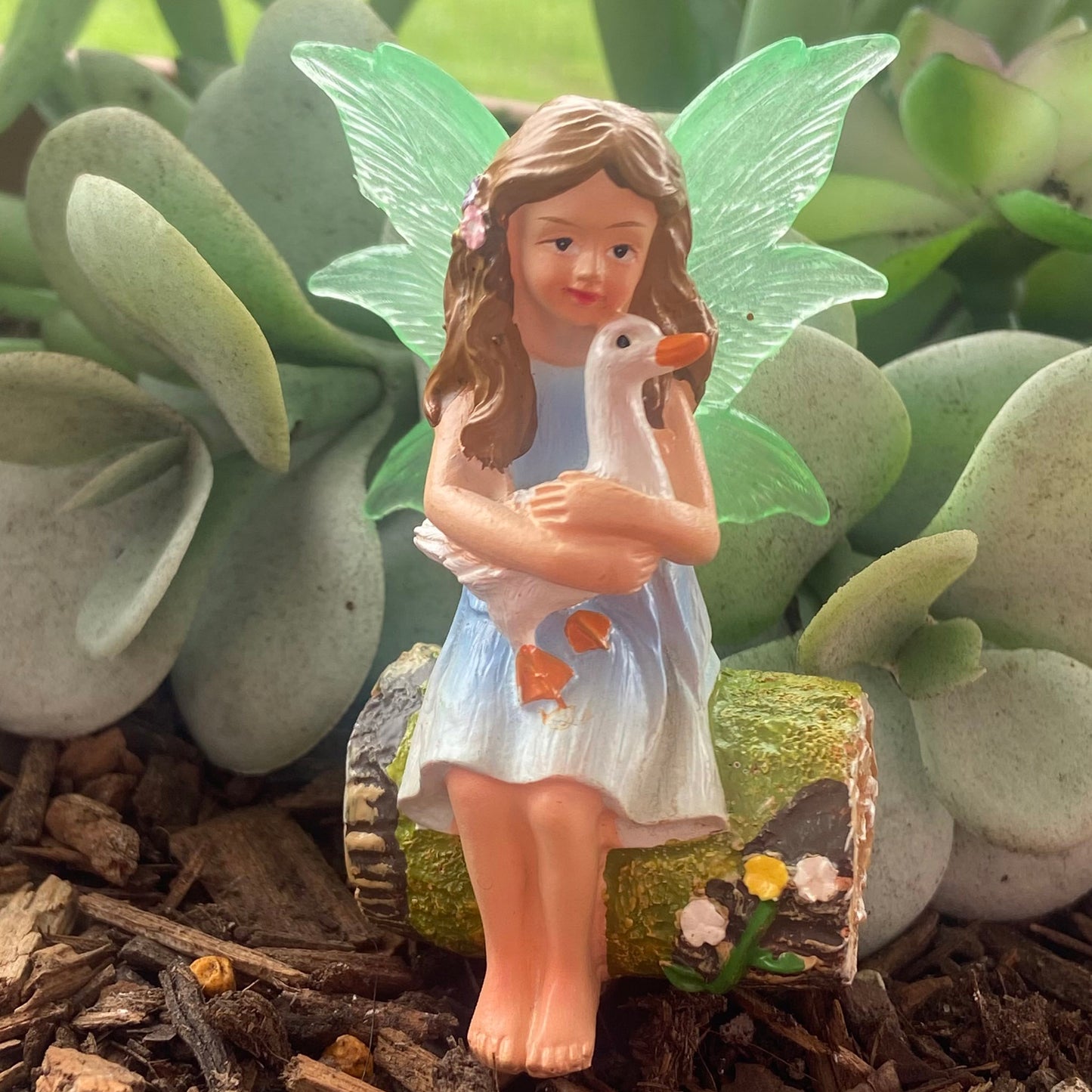 Fairy Sitting on Log Holding Duck Figurine