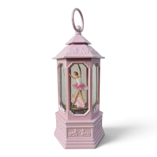 A pink lantern with a ballerina figurine inside, a snow globe