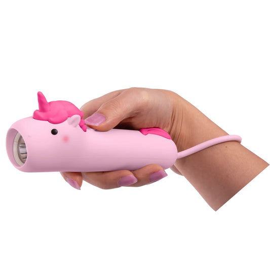 Hand holding a pink flashlight shaped like a unicorn on a white background