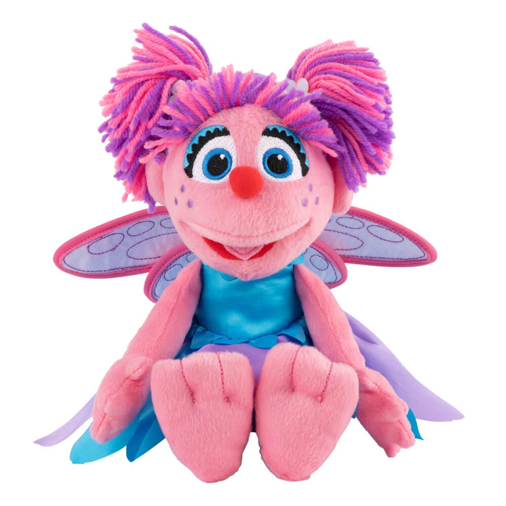 Plush toy with pink and purple hair, blue eyes, and butterfly wings on a white background